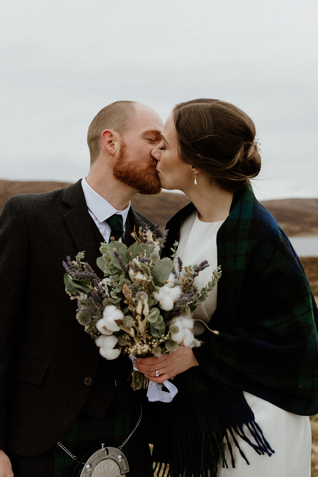 A couple share a kiss after their intimate wedding in the Shetland Islands.