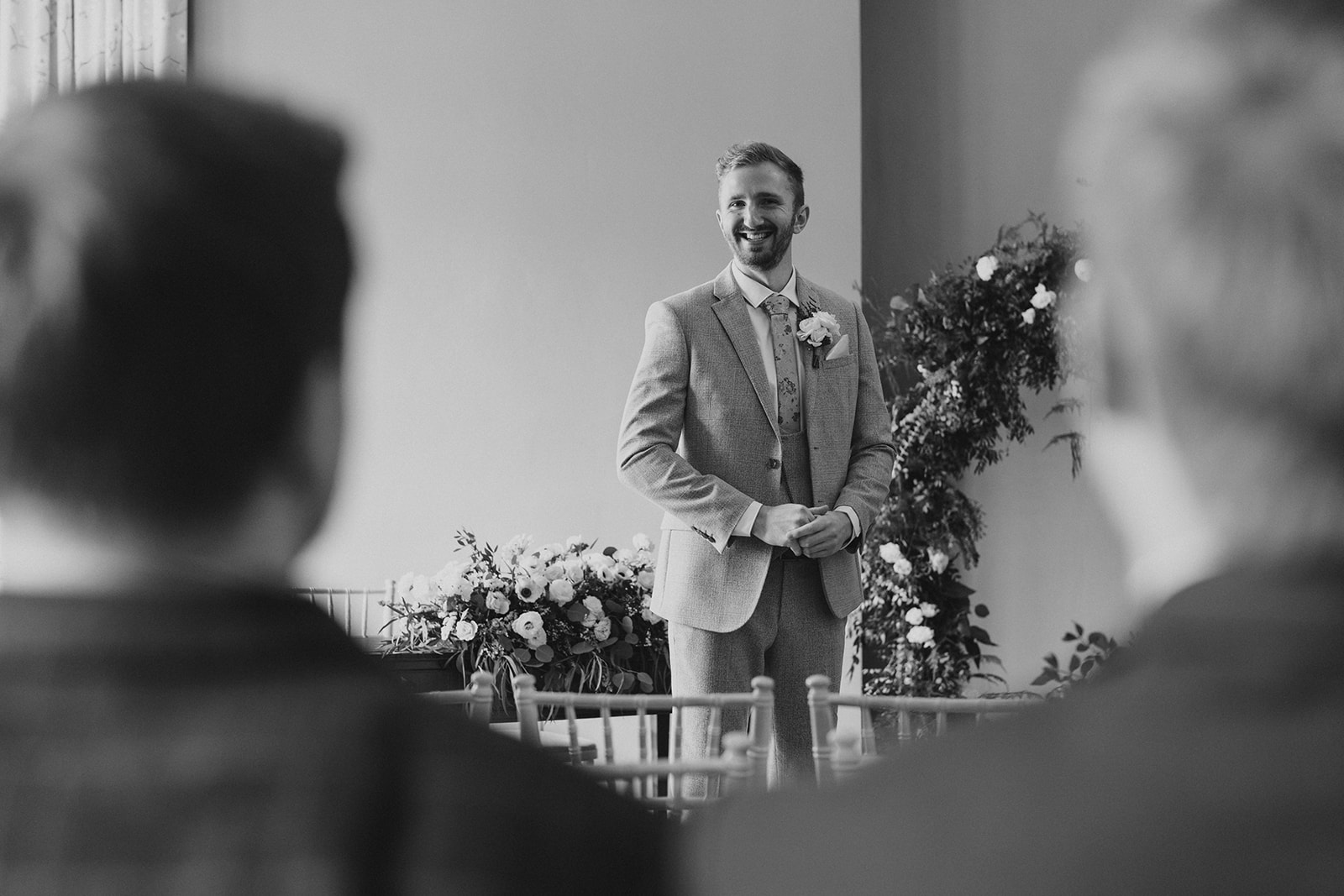The groom, laughing, waiting for the start of the wedding ceremony
