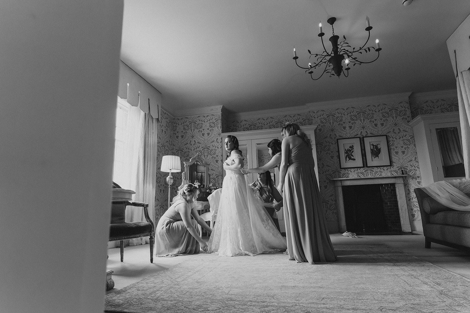 The bride having help with her wedding dress on the morning of her wedding