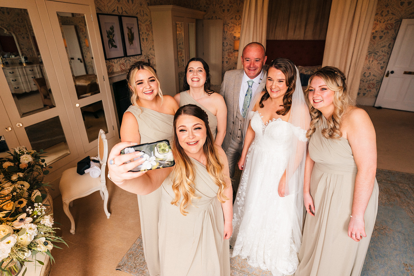 A bridesmaid doing a bridal party selfie before the start of the wedding ceremony