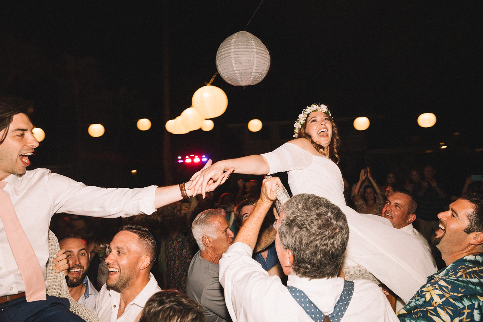 Couple is lifted for the chair dance while their family and friends dance the hora around for this wedding tradition.
