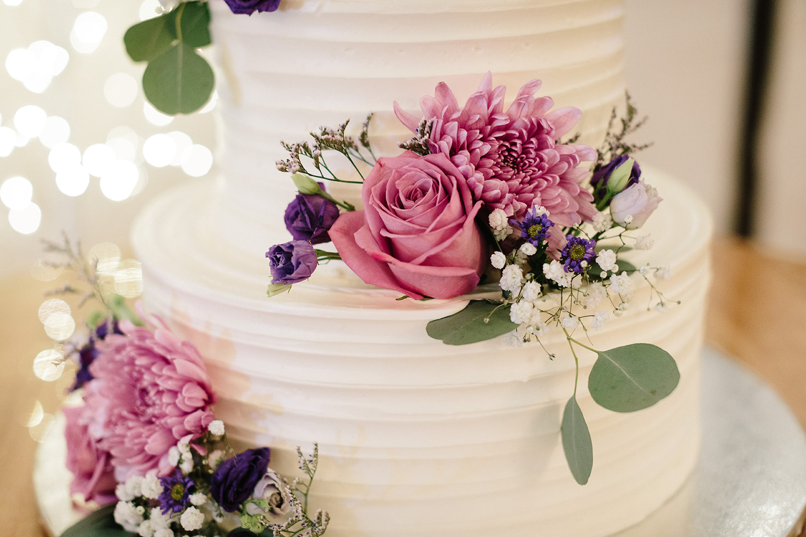 Flowers sitting on a wedding cake 