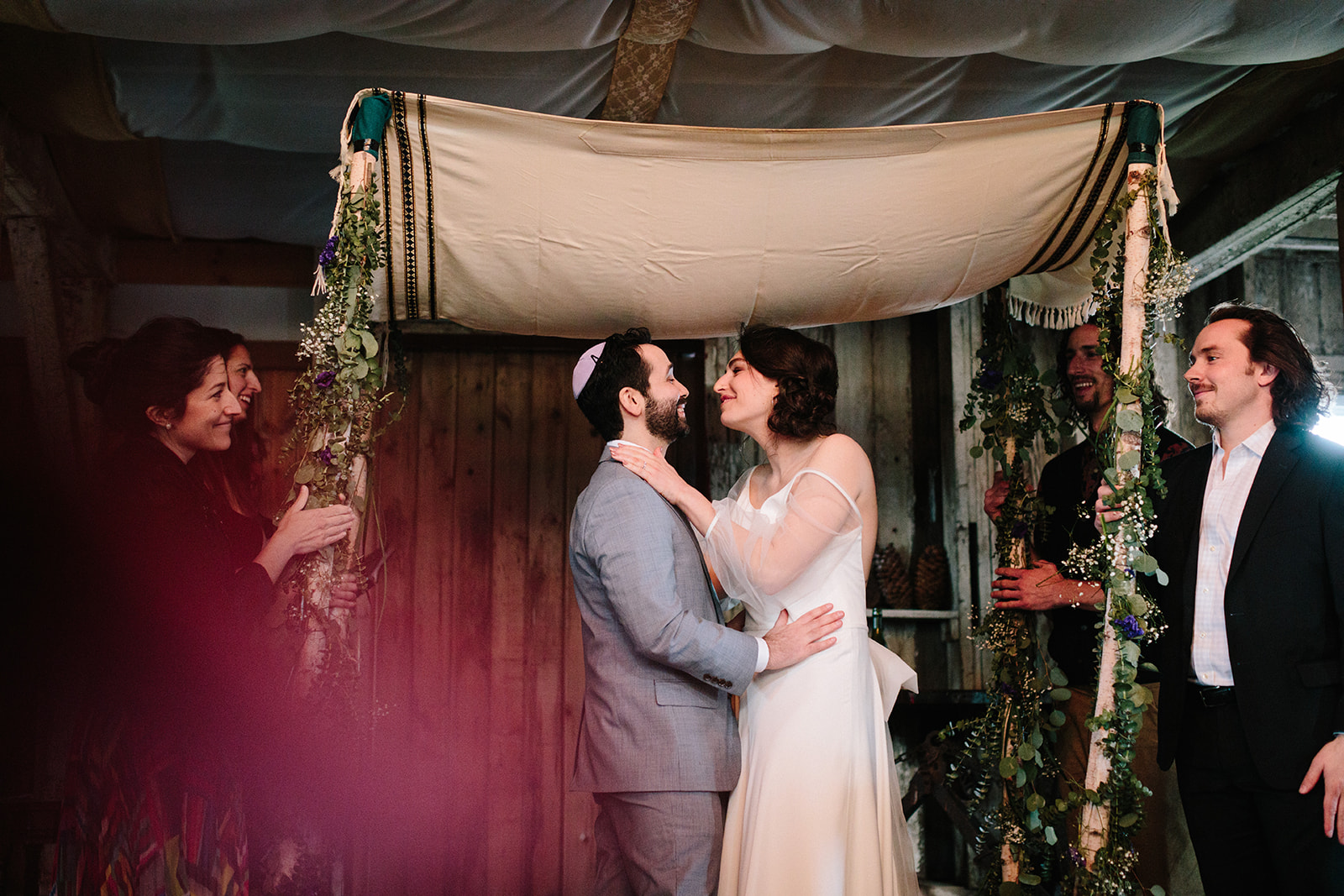 a male and female kiss under the chuppah in Illinois