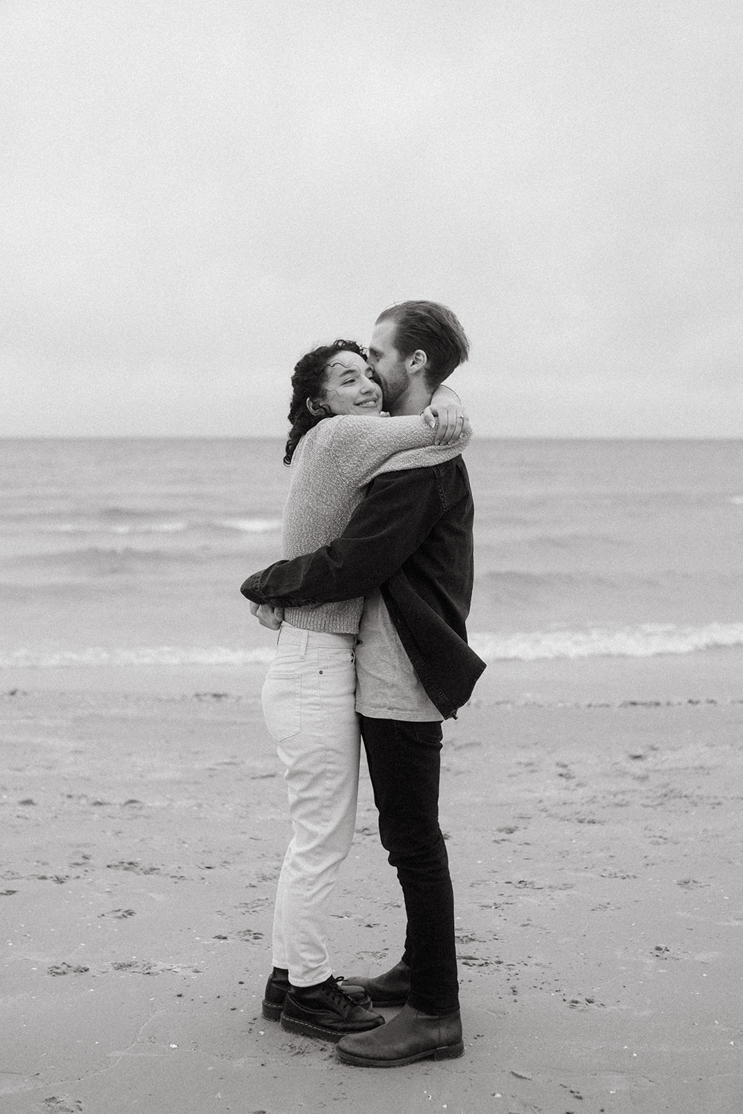 couple hugging on shore of Lake Ontario