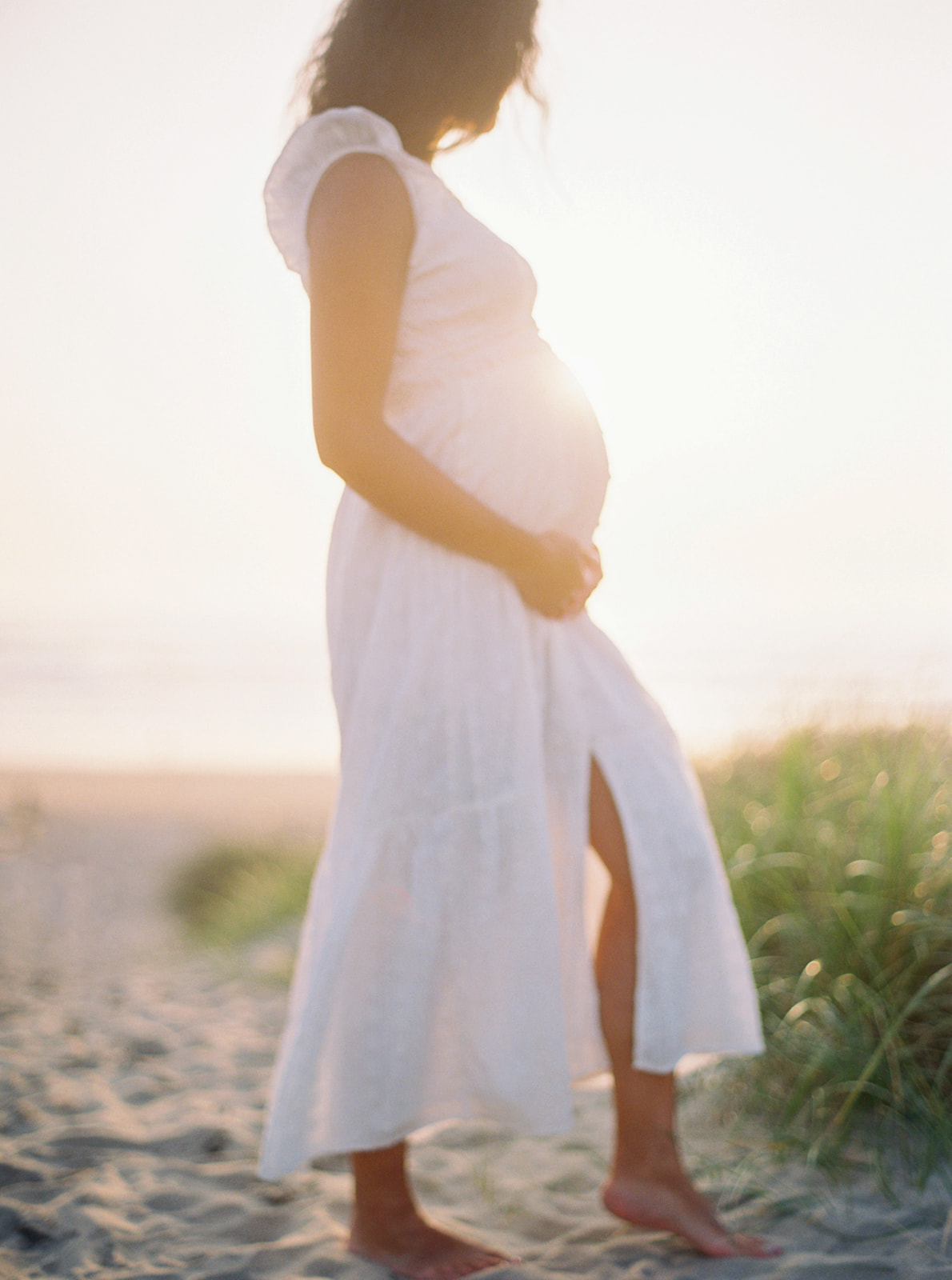 an expectant mom poses for her Cannon Beach maternity photos