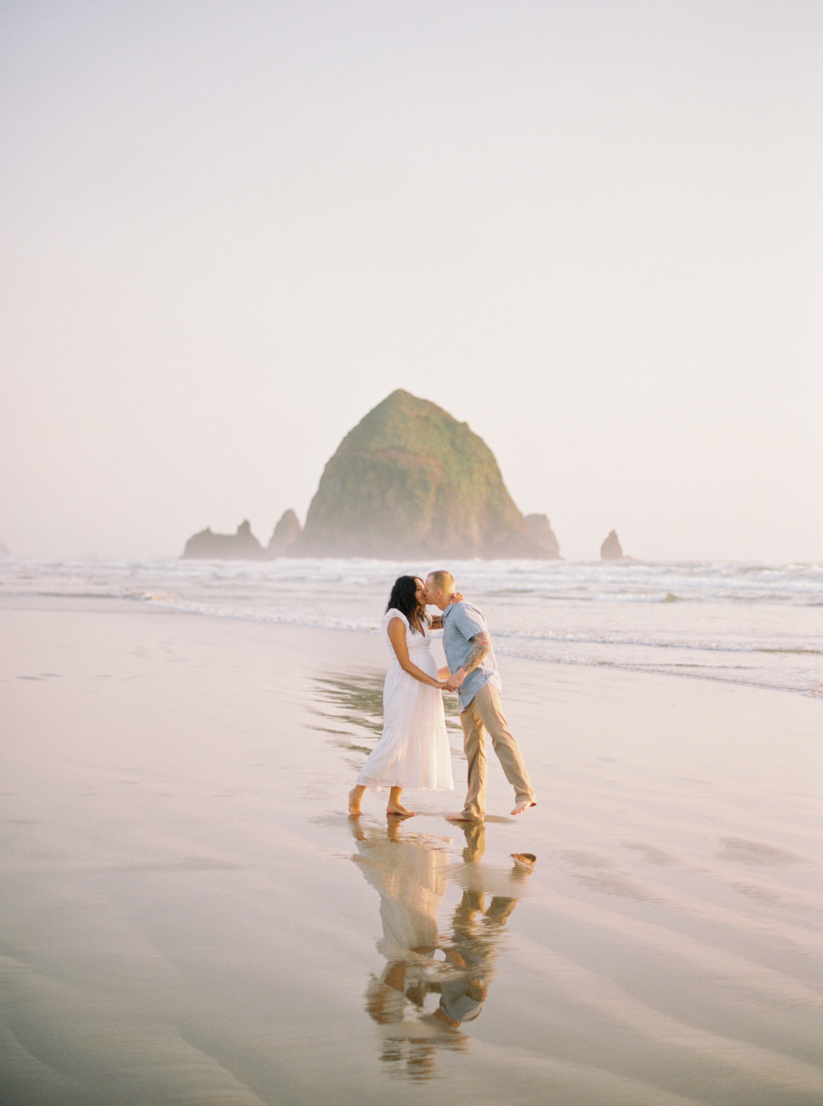 a couple in front of Haystack Rock at Cannon Beach, on 120mm film