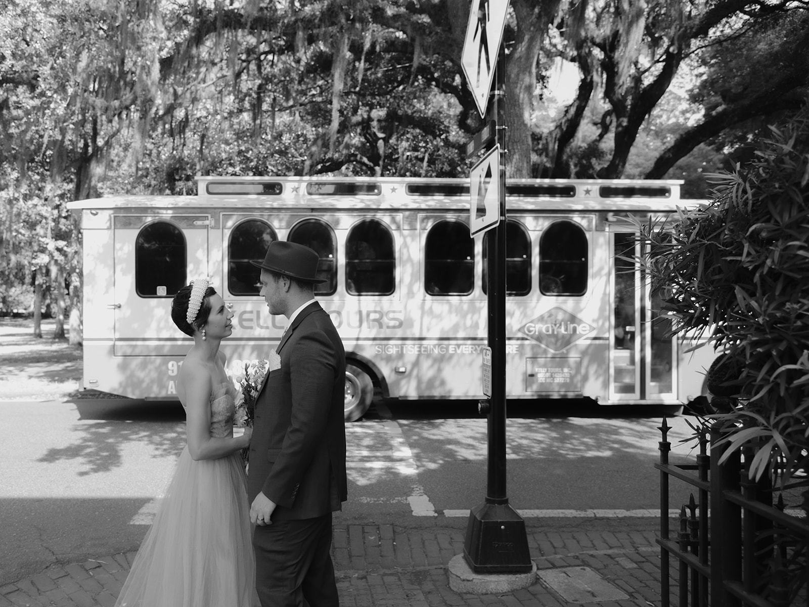 A Savannah street car passes by in the background where this couple has just eloped in the streets