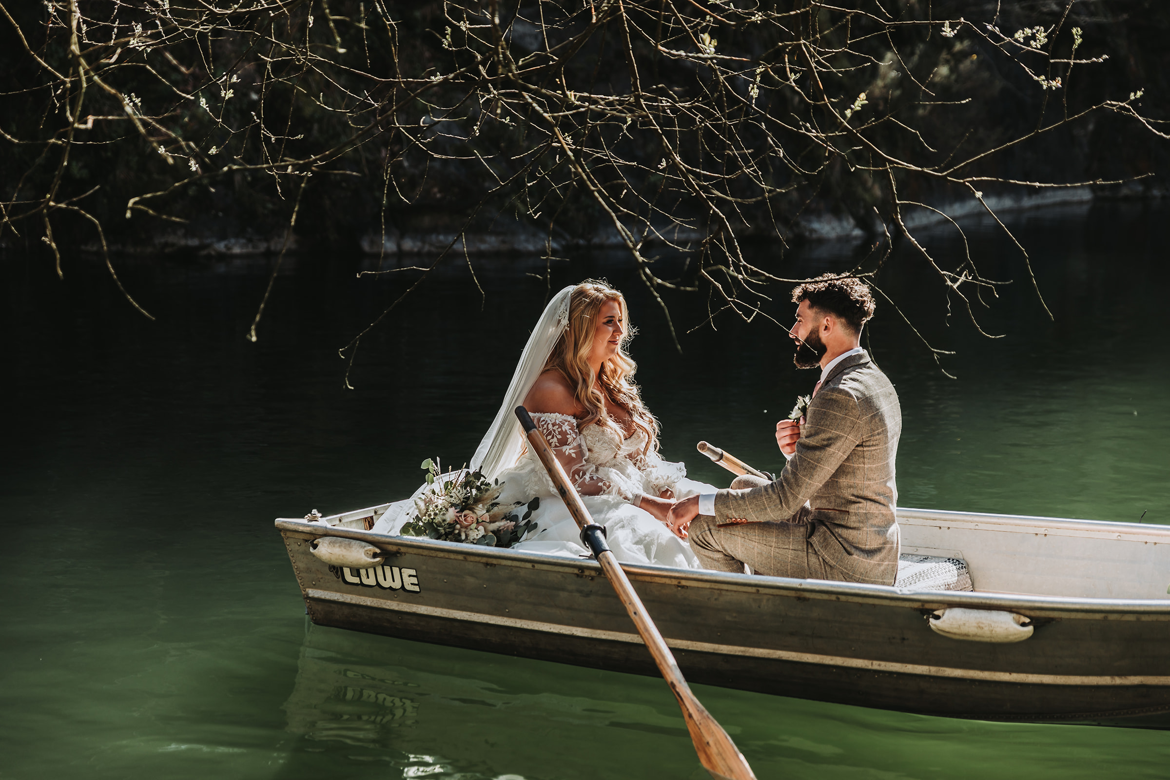 bride and groom paddle boating in a cornish quarry