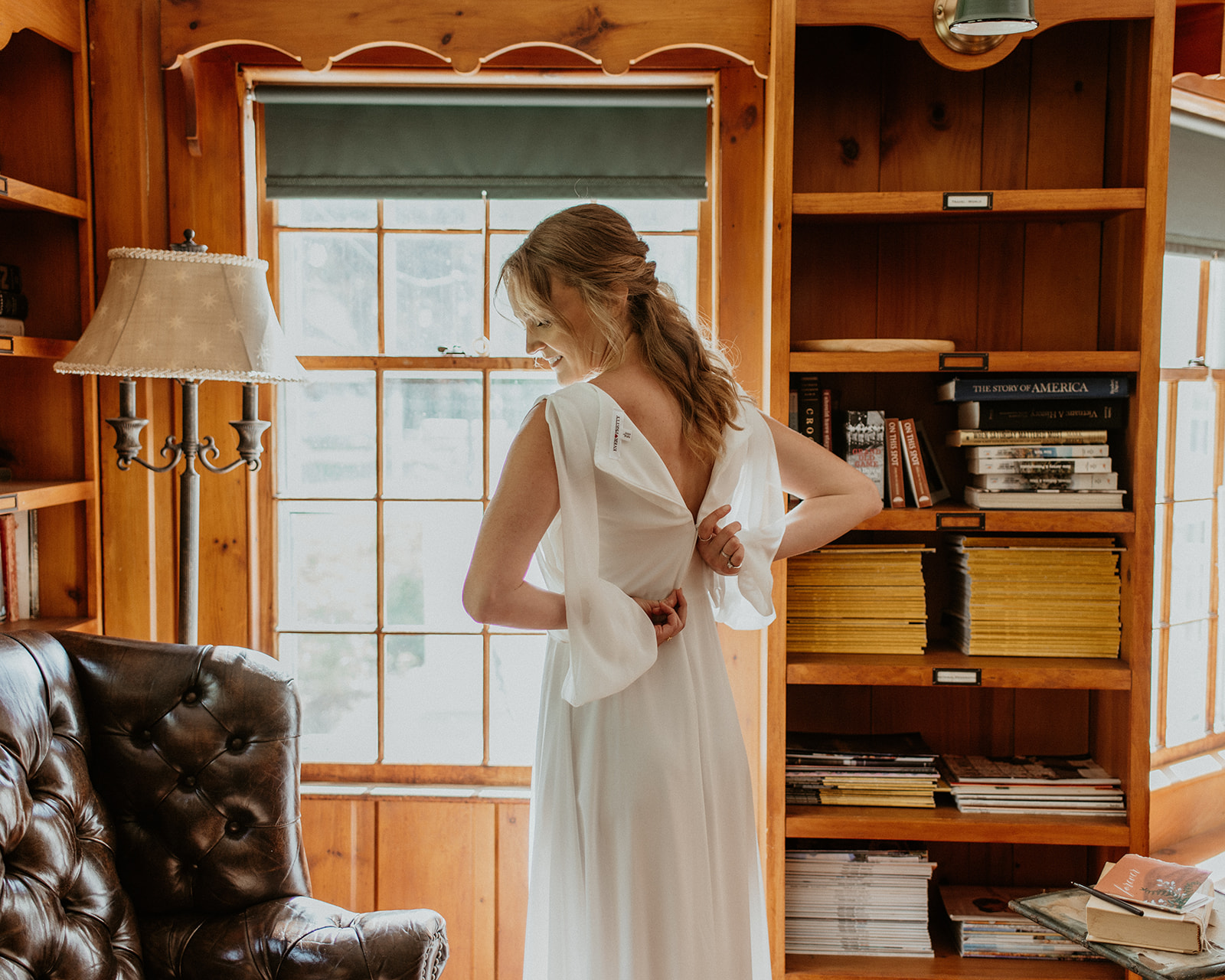 Bride gets into wedding dress at Horse and Hound Inn Franconia New Hampshire