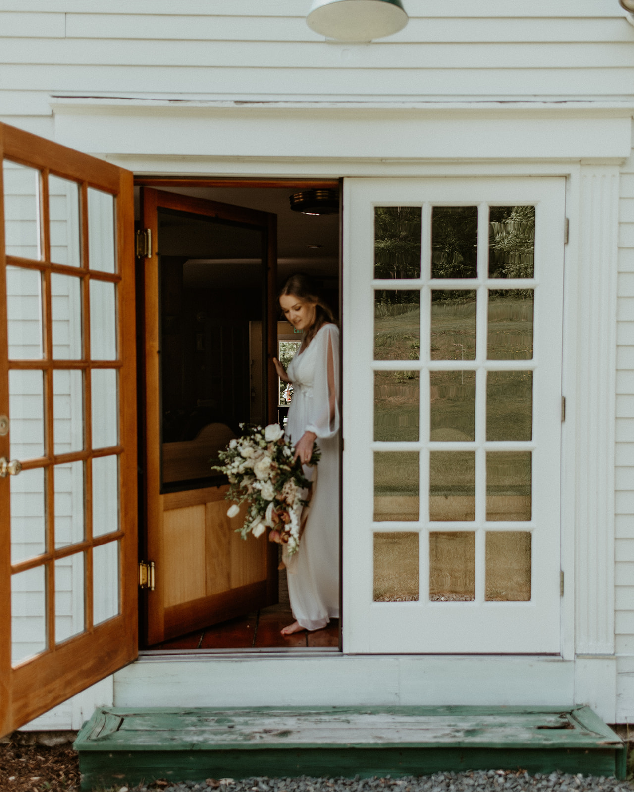 Bride walks outside of Horse and Hound Inn during elopement