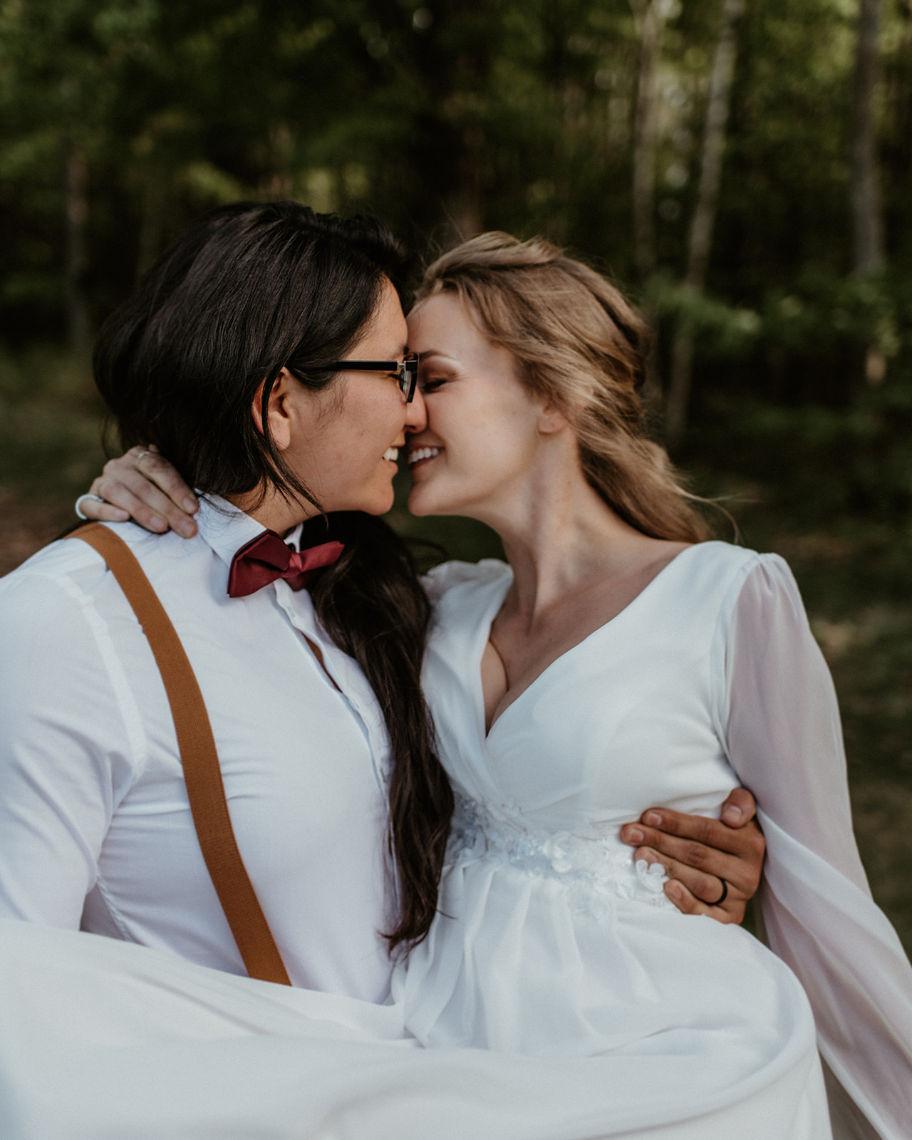 Brides kiss during portraits at their New Hampshire Elopement