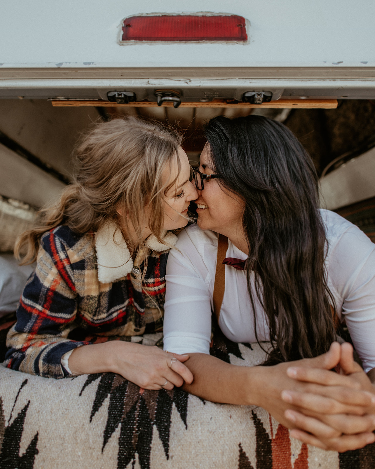Brides kiss in Camper van during White Mountains Elopement