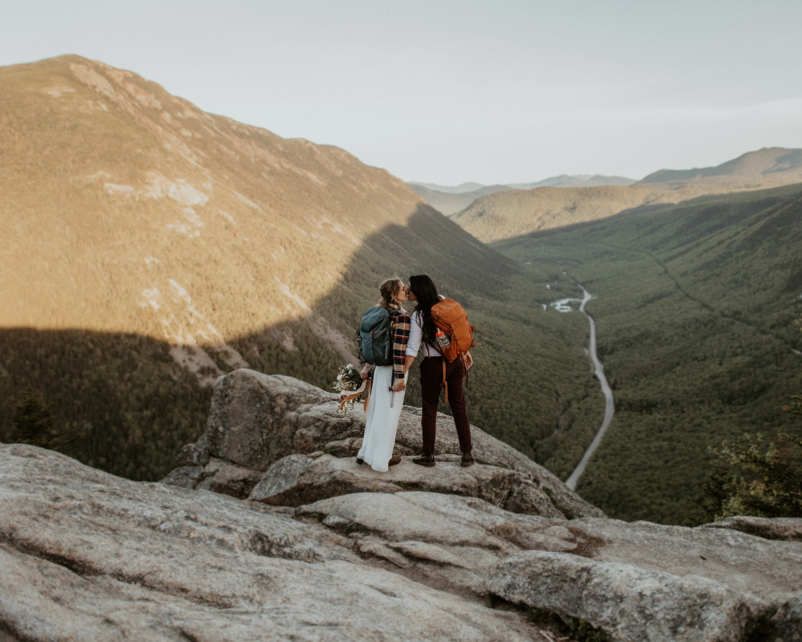 Couple kiss with view of Crawford Notch New Hampshire elopement