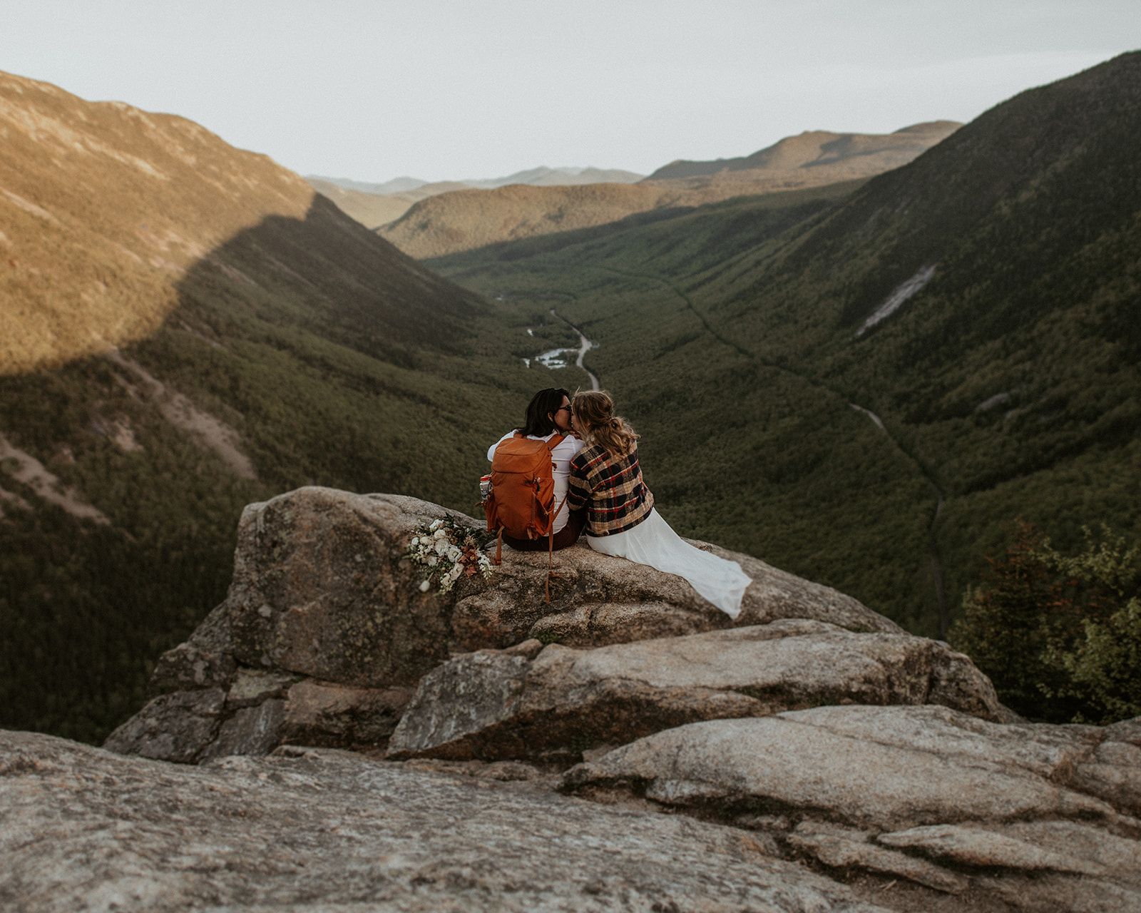 Brides sit together with view of Crawford Notch