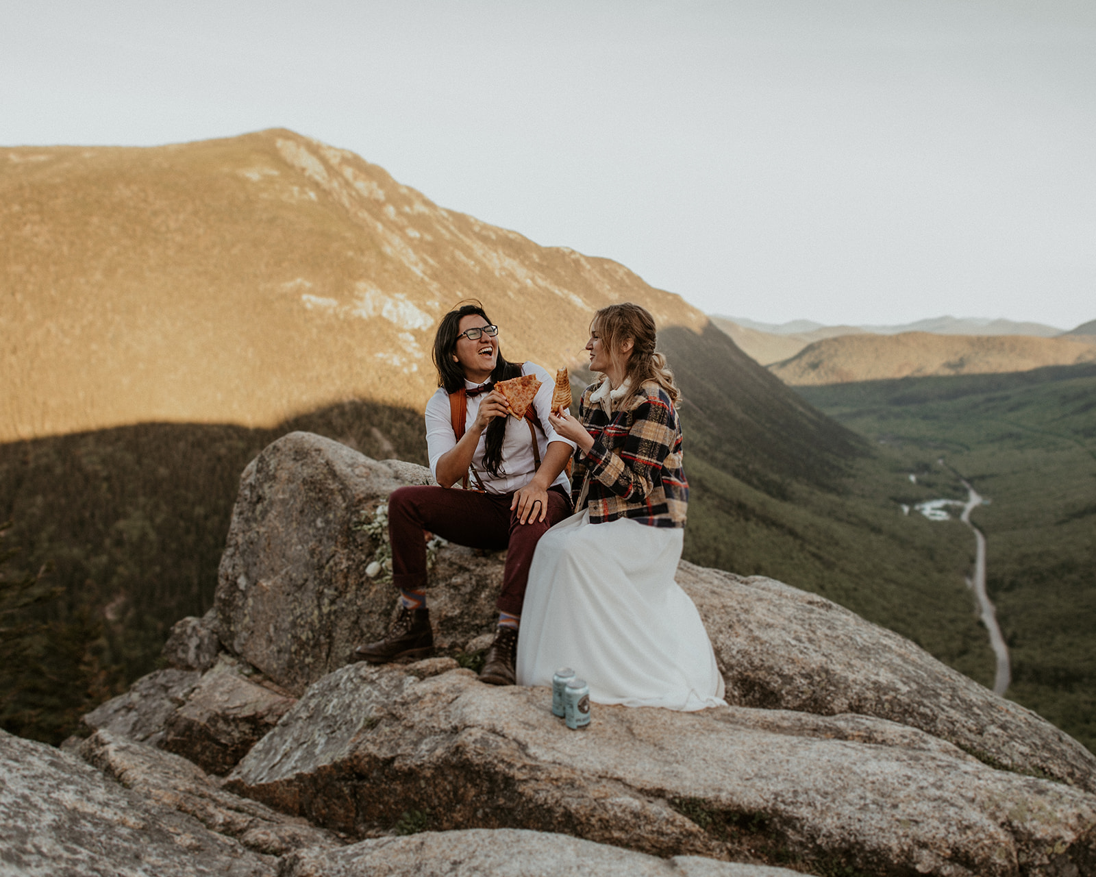 Brides share pizza and beer during their White Mountains Elopement