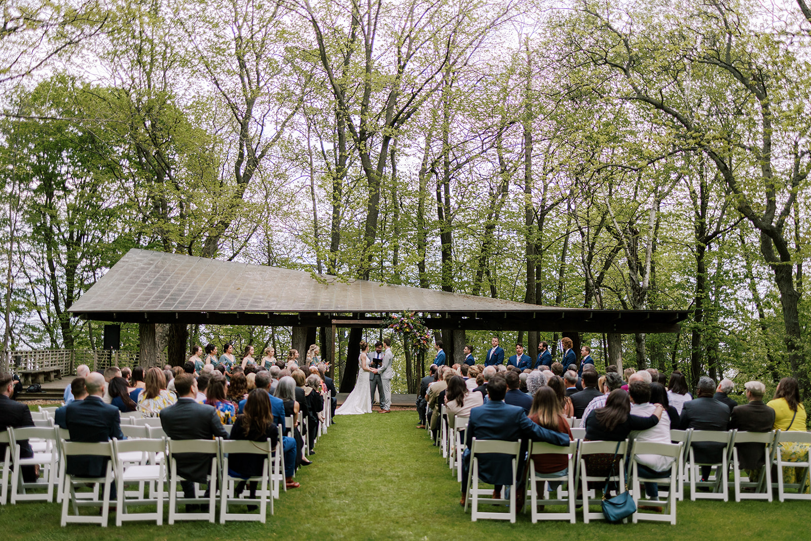 bride and groom have their ceremony at schlitz audubon nature center in milwaukee wisconsin