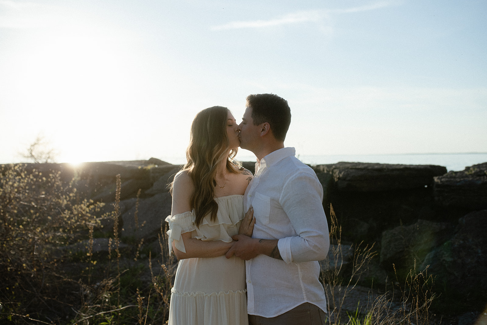 couple kissing during maternity session at Westcott beach