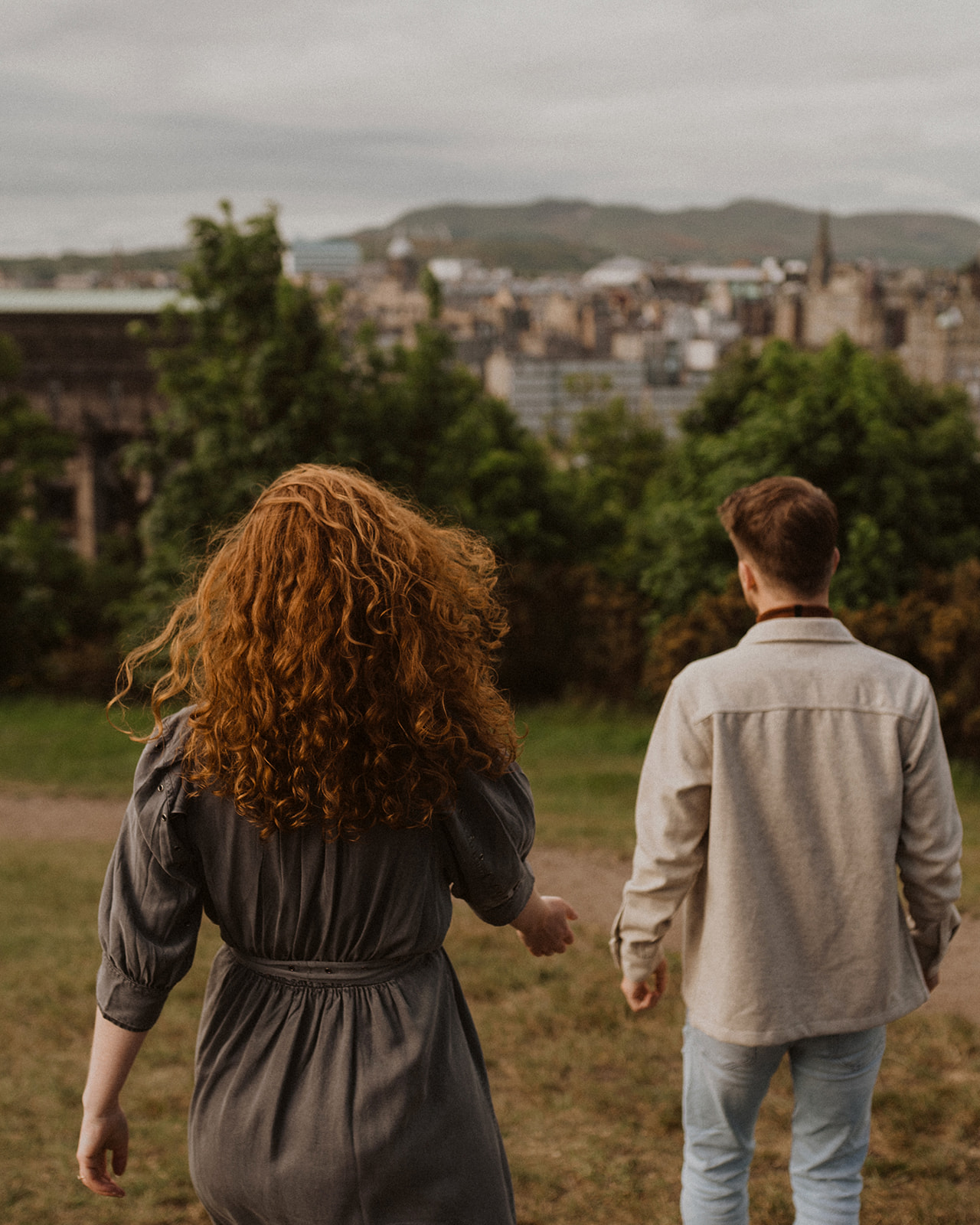 Couple look over Edinburgh Castle during photoshoot 
