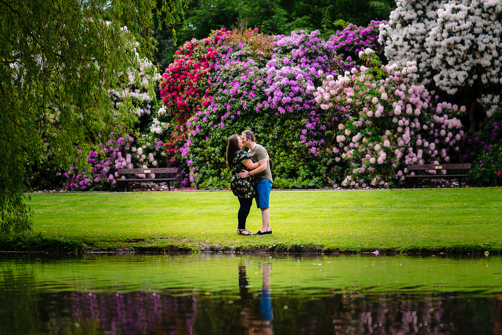 Couple embrace next to the lakes in temple newsam