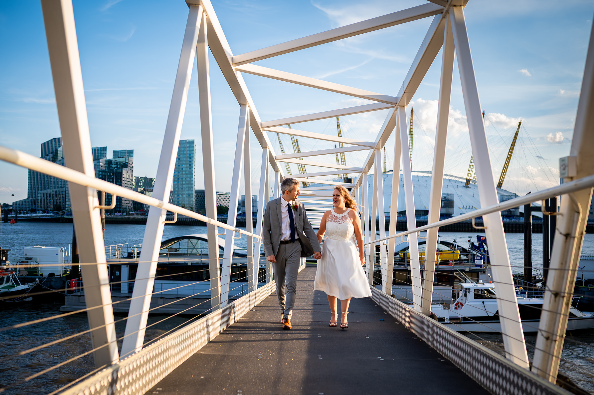 Couple walking over a bridge at their Trinity Buoy Wharf Wedding 
