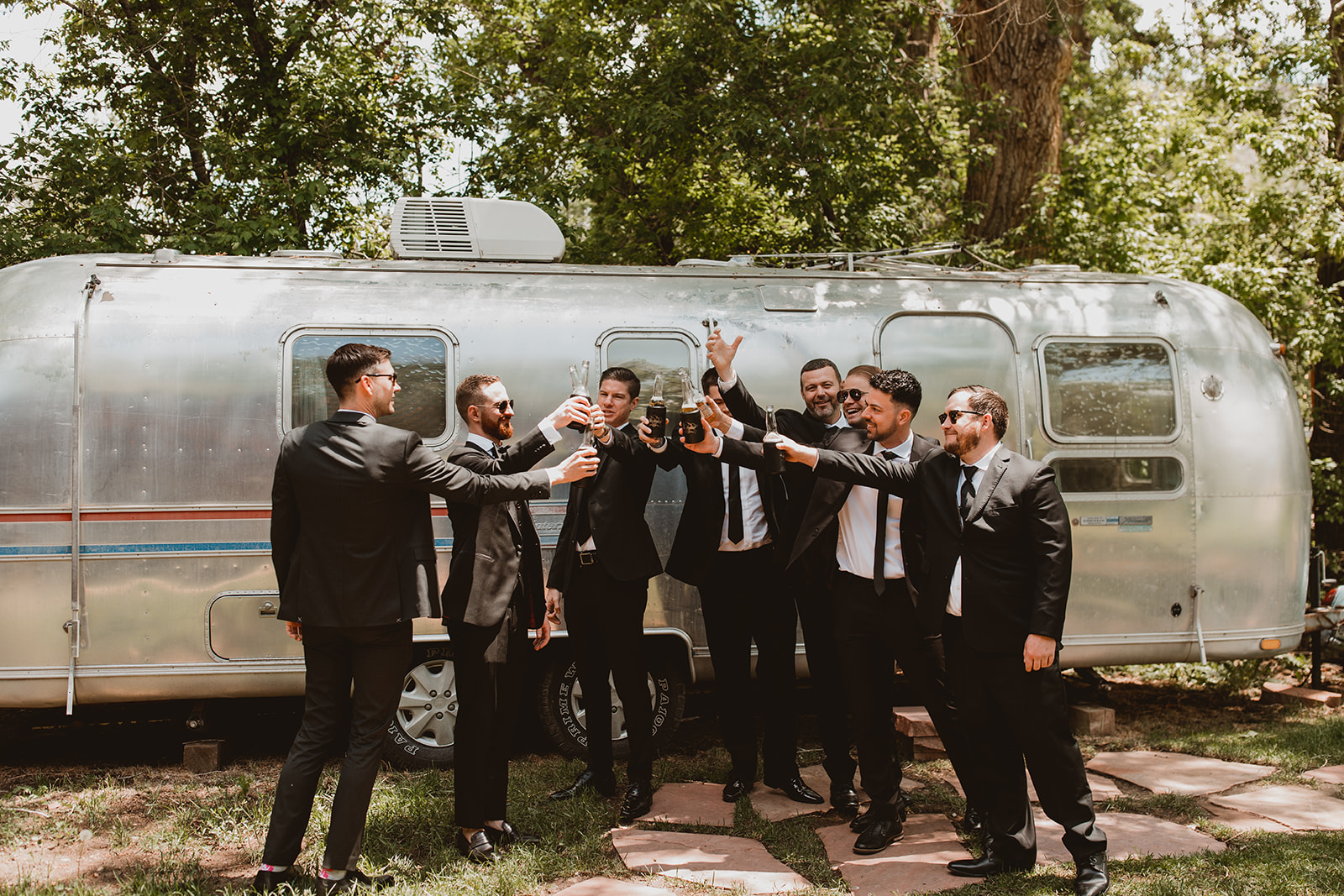Groomsmen cheers as they get ready for their wedding day in Denver Colorado at Lyons Farmette