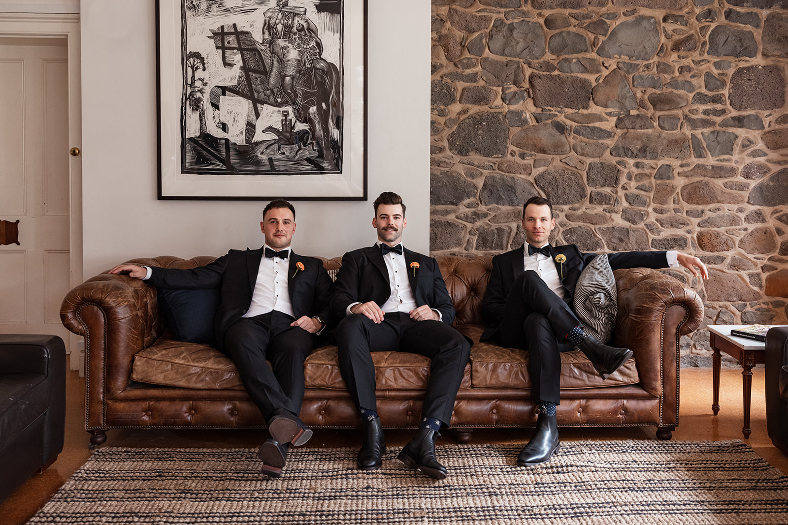 Groomsmen sitting on a couch