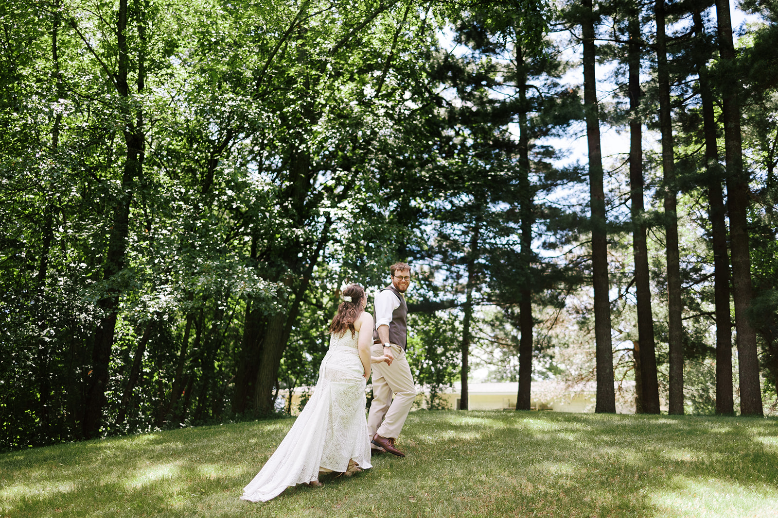 couple walks together after their first look during their intimate backyard wedding in central wisconsin