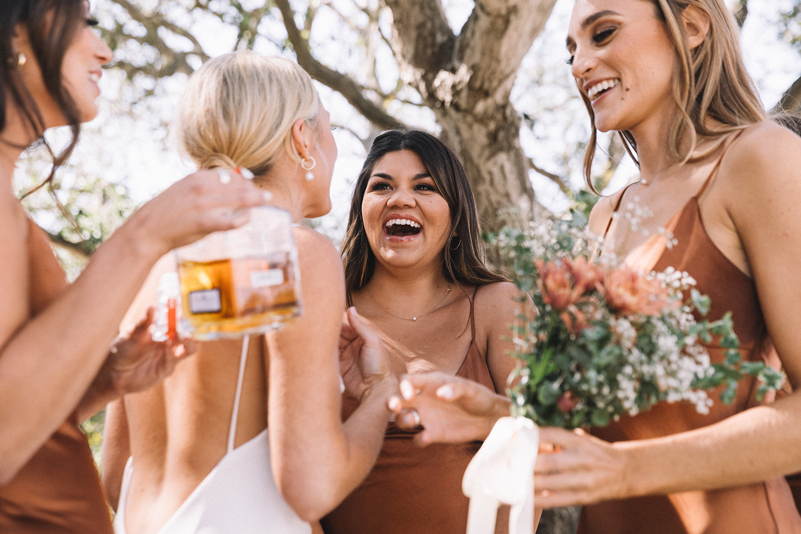 Bridesmaids take a celebratory drink before walking down the isle for this summer Santa Barbara wedding. 