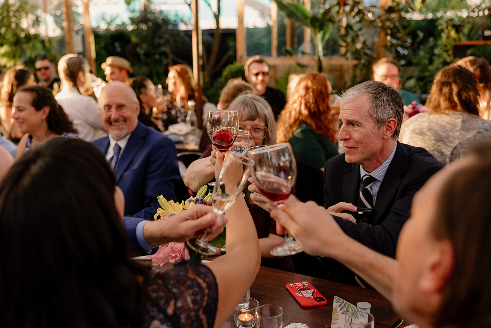 Guests laughing and toasting at a Blockhouse wedding in Portland. 