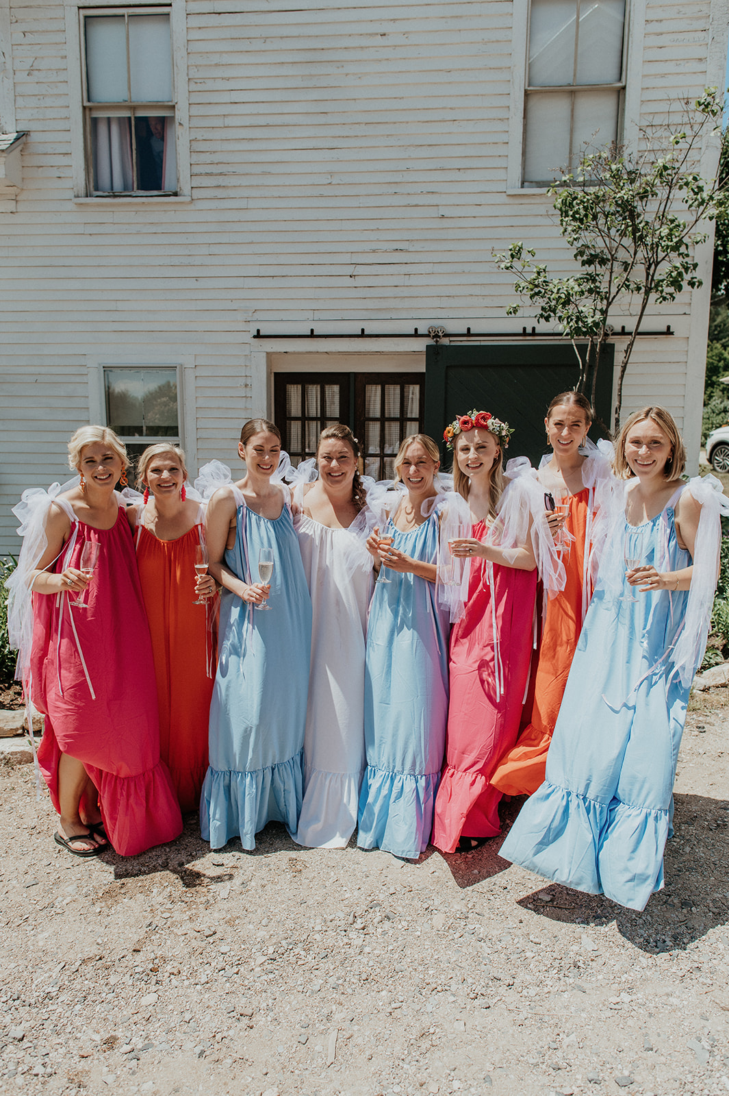 Bride standing with bridesmaids outside