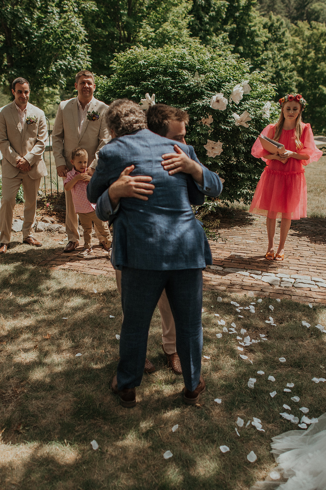 Groom embraces father of the bride during ceremony