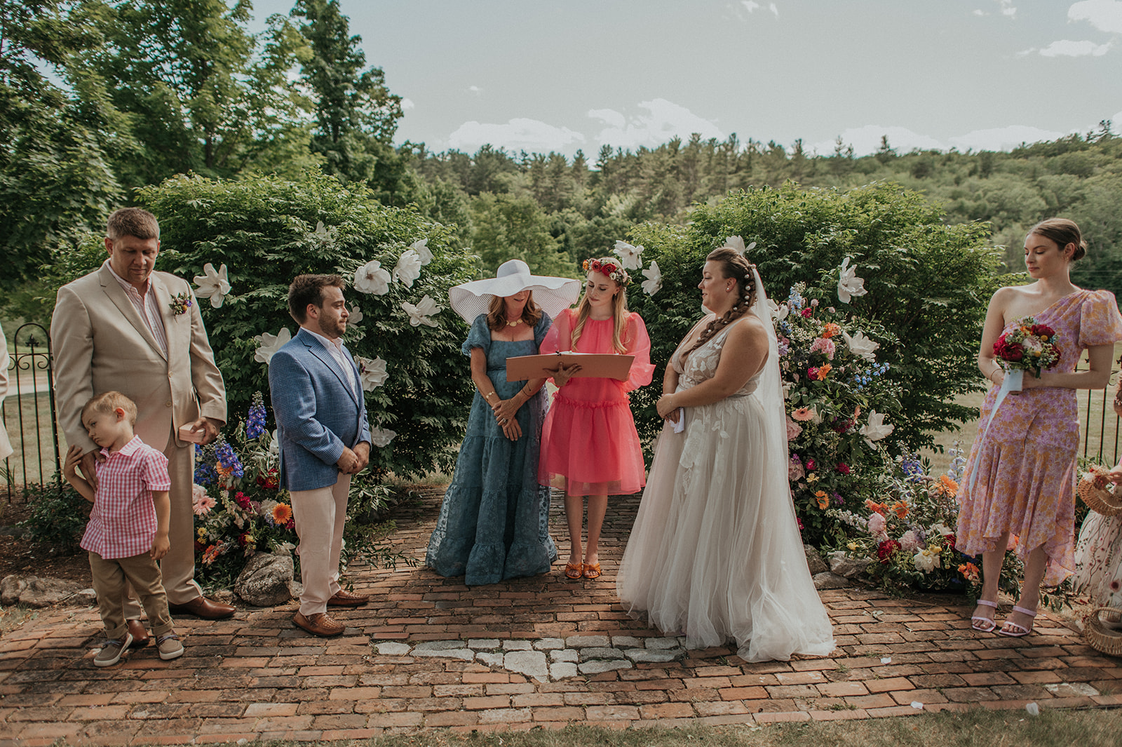 Bride and groom stand facing each other during wedding ceremony at the preserve at chocorua