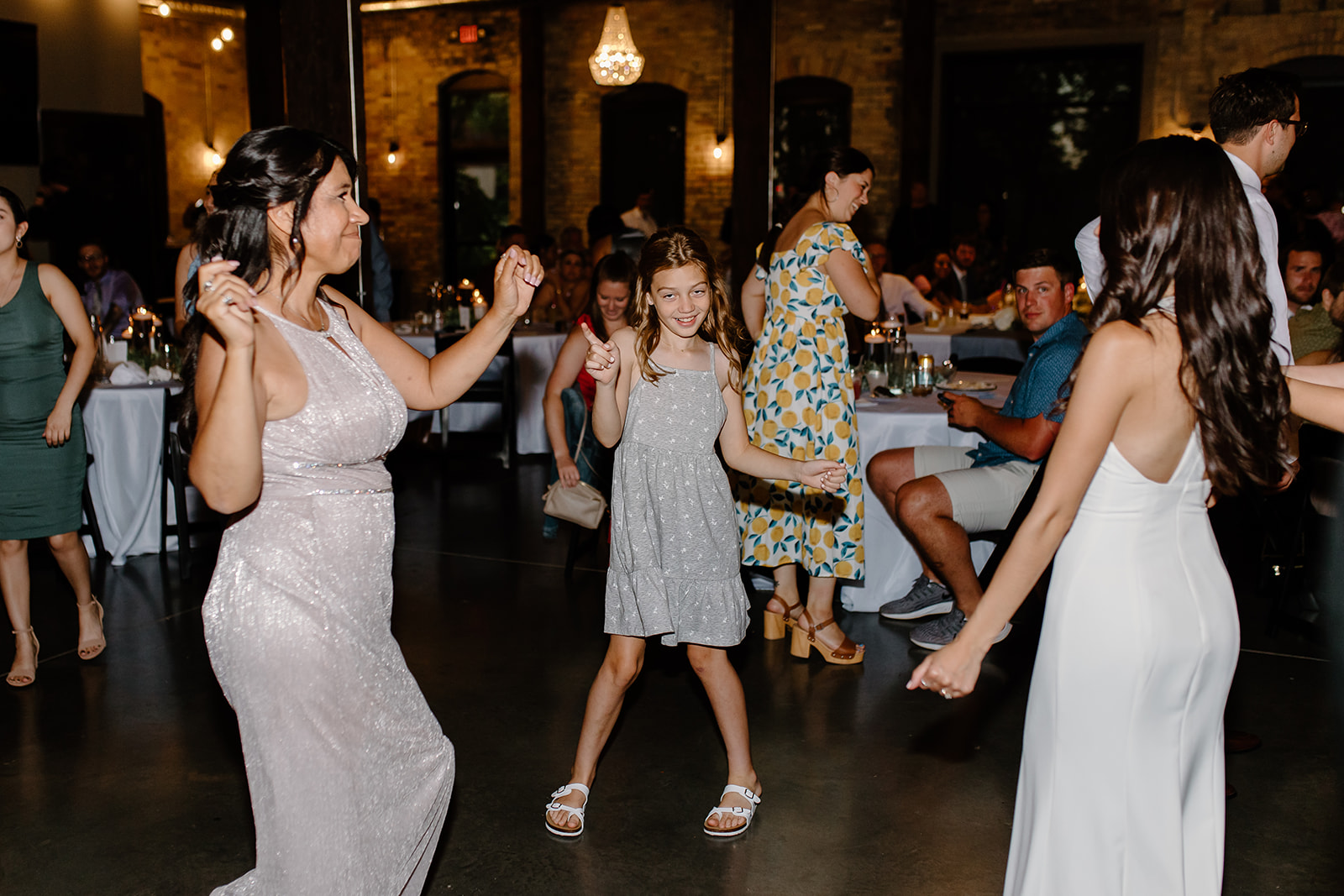 Bride dances with guests on the dance floor