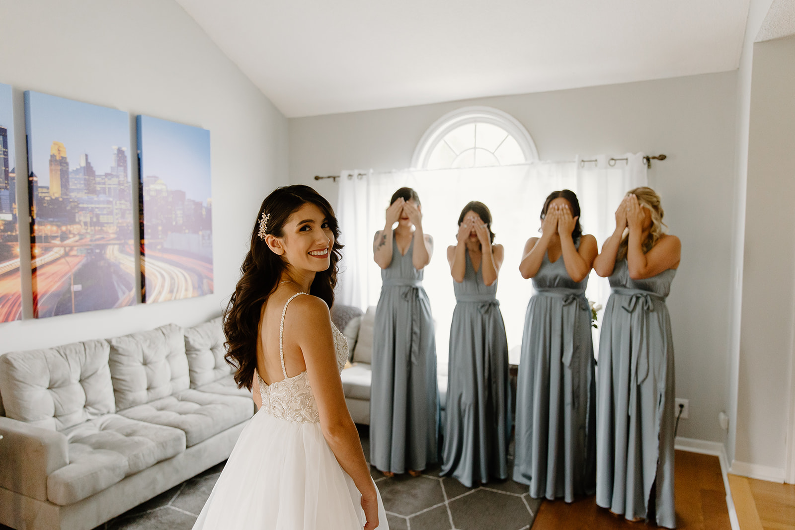 Bride looks over her shoulder while standing in front of her bridesmaids