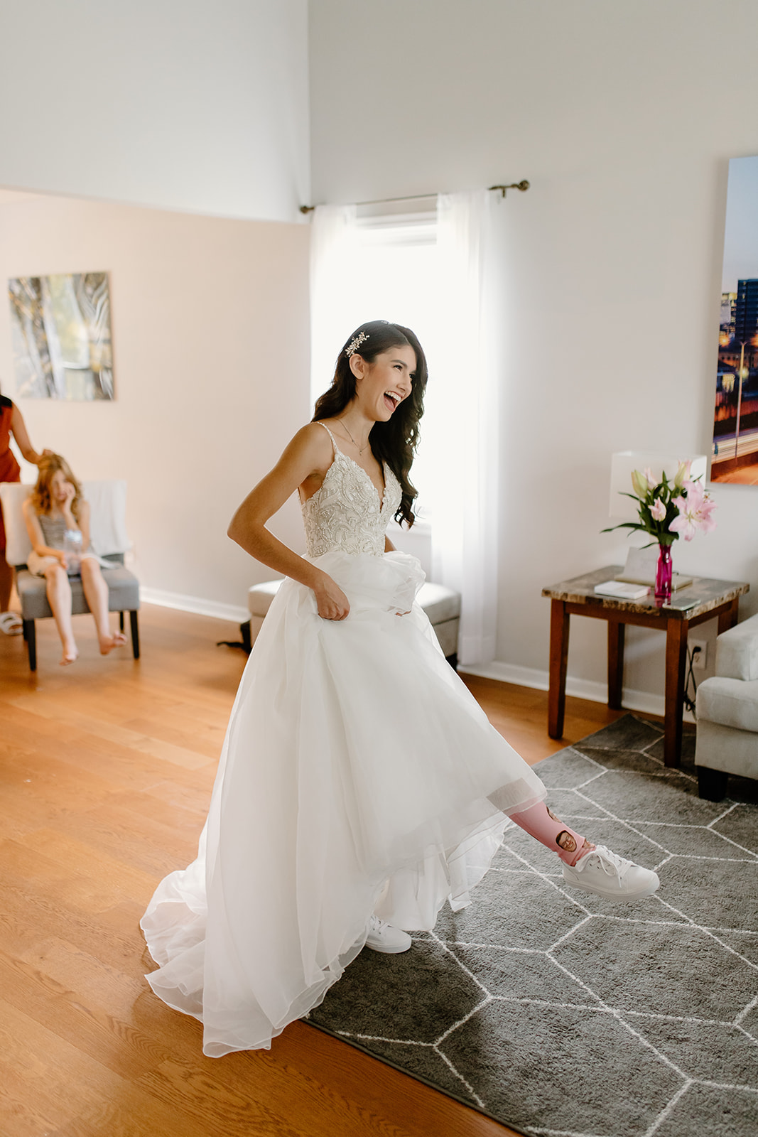 Bride smiles and shows off her socks in her wedding dress