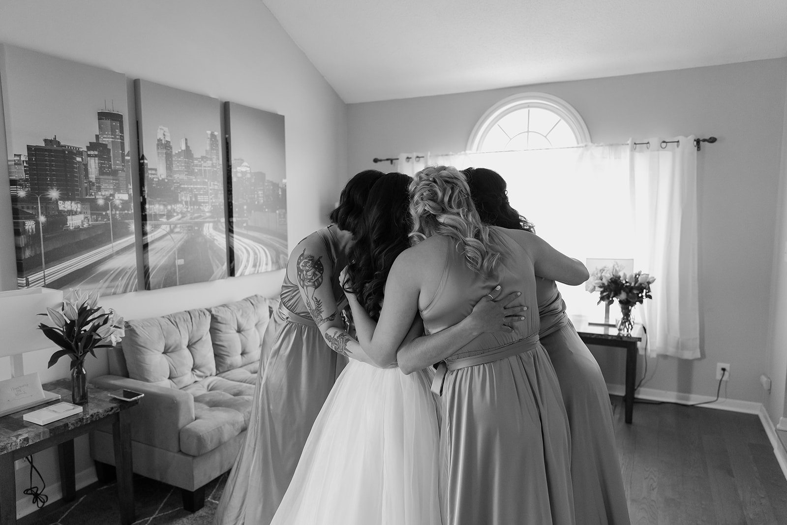 Bride and her bridesmaids share a group hug