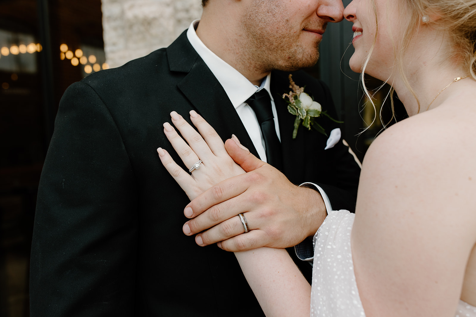 Close up of the rings on a bride and groom's fingers