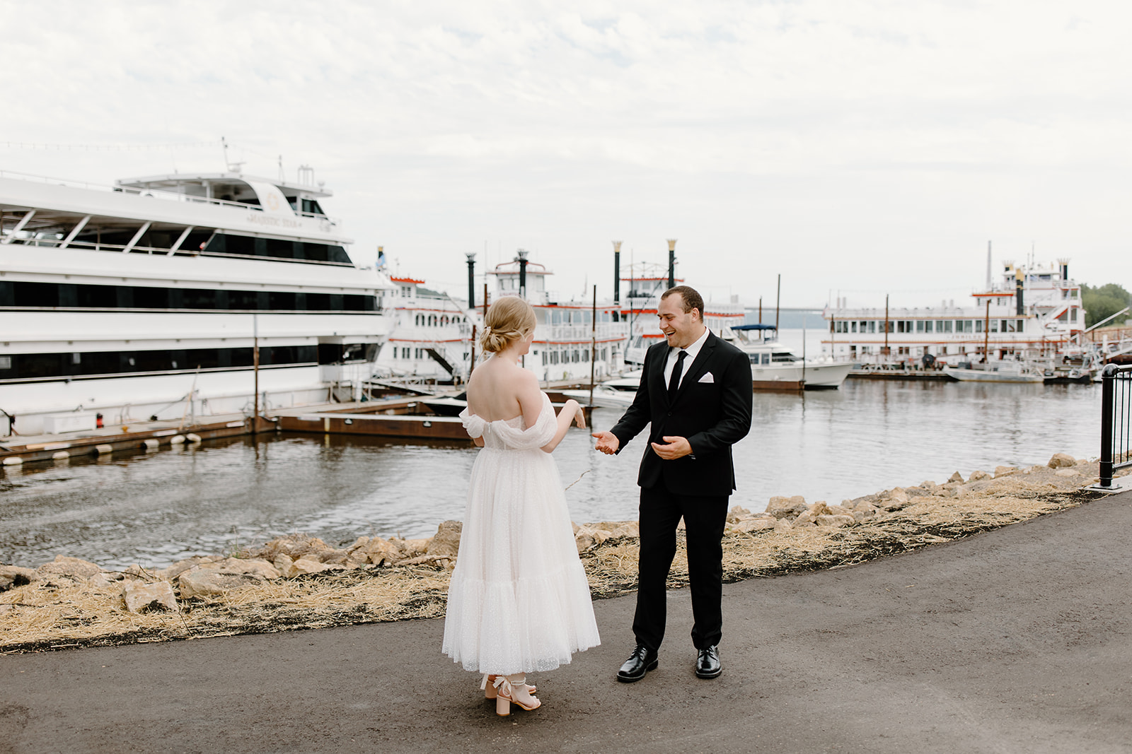 Bride and groom see each other for the first time on their wedding day in front of a yacht
