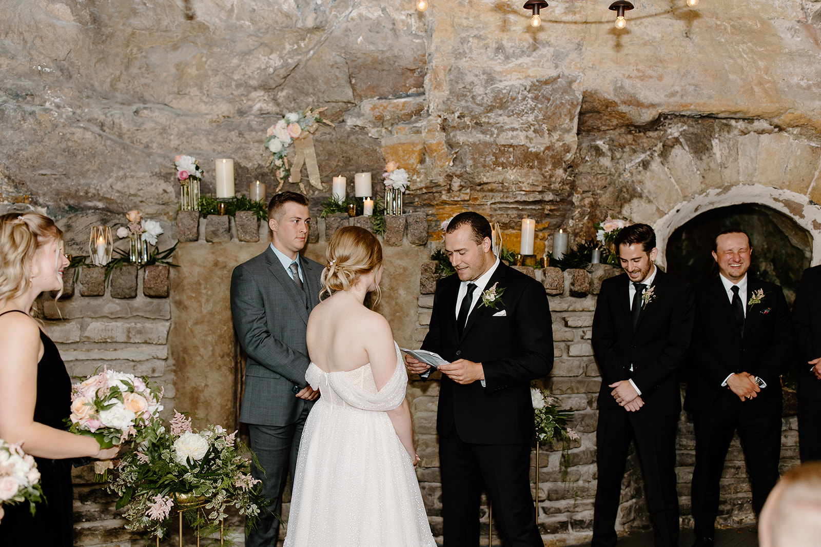 Bride and groom read vows during their ceremony in a cave