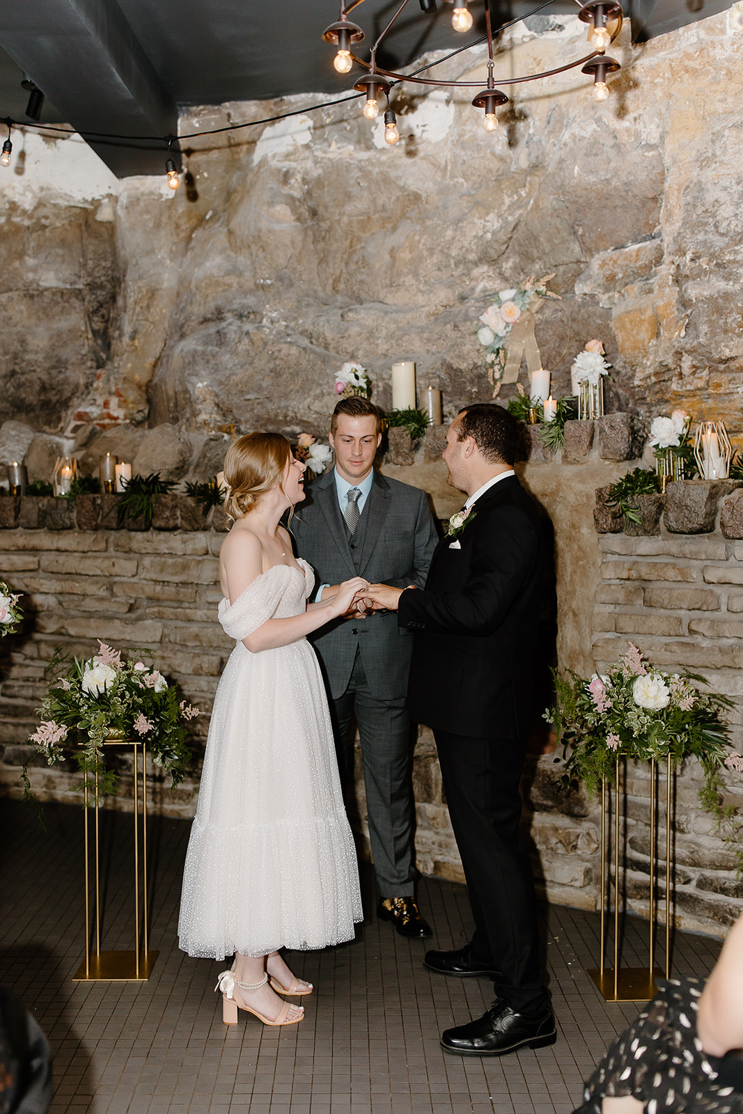Bride and groom read vows during their ceremony in a cave