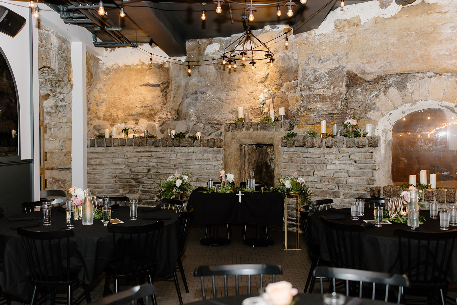 Wedding tables and chairs set up inside of a cave
