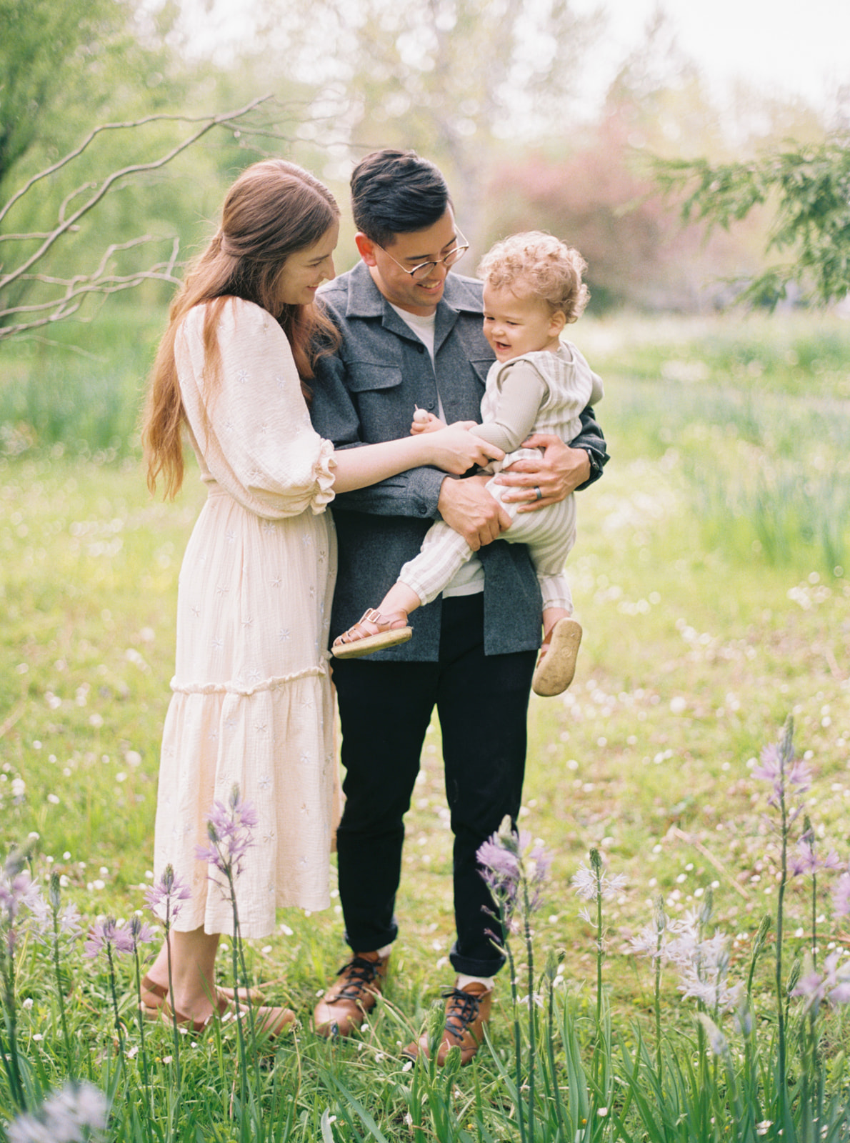 a young family hugs playfully in a wildflower field in Wilsonville, Oregon