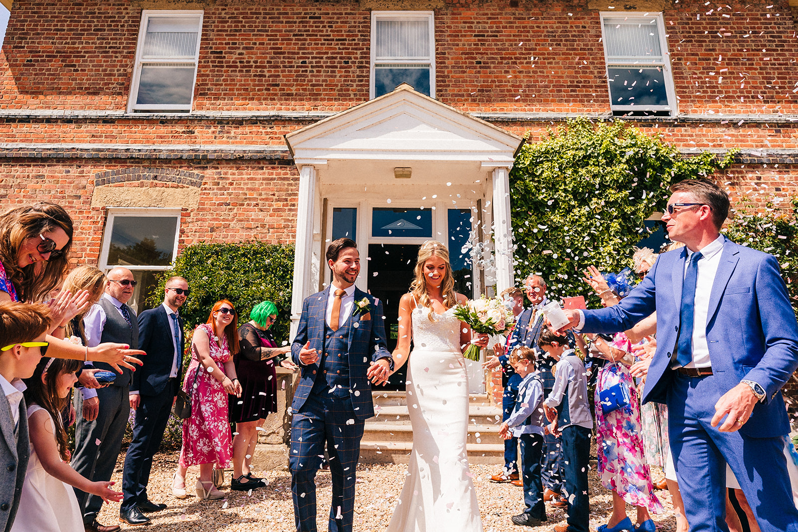 Shottle Hall Wedding Photography - the bride and groom get covered in confetti