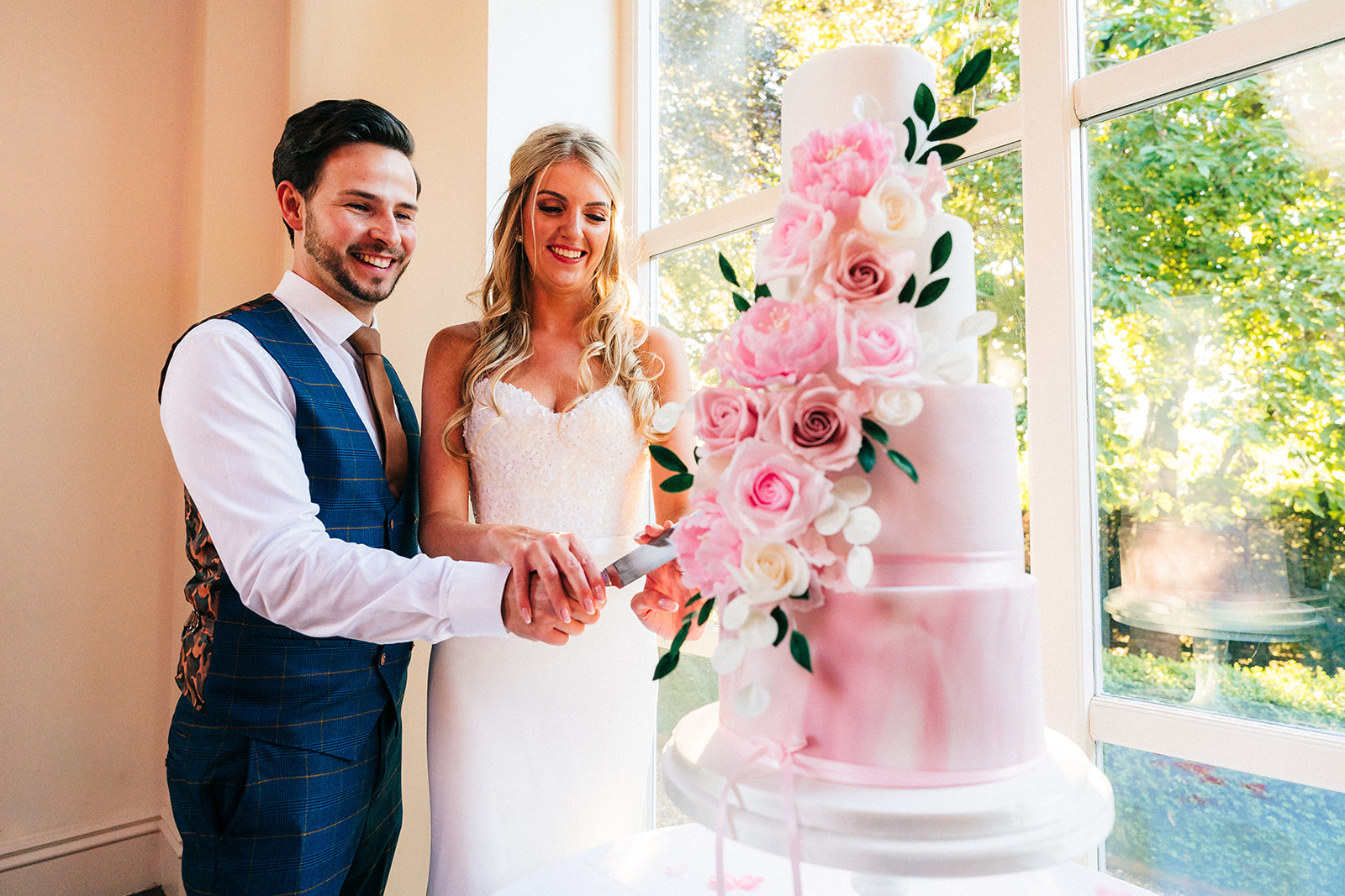 Shottle Hall Wedding Photography - the bride and groom cutting the wedding cake