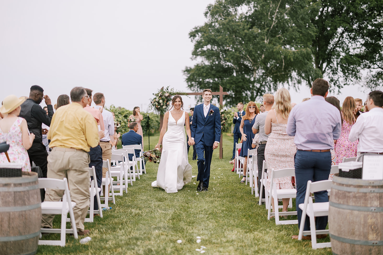 couple walks down aisle as husband and wife during wedding at over the vines in edgerton wisconsin