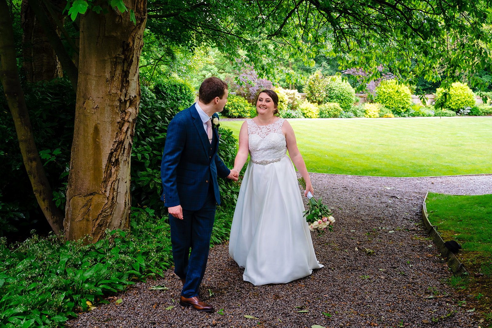 Bride and groom hold hand in the grounds of Woodlands Hotel 
