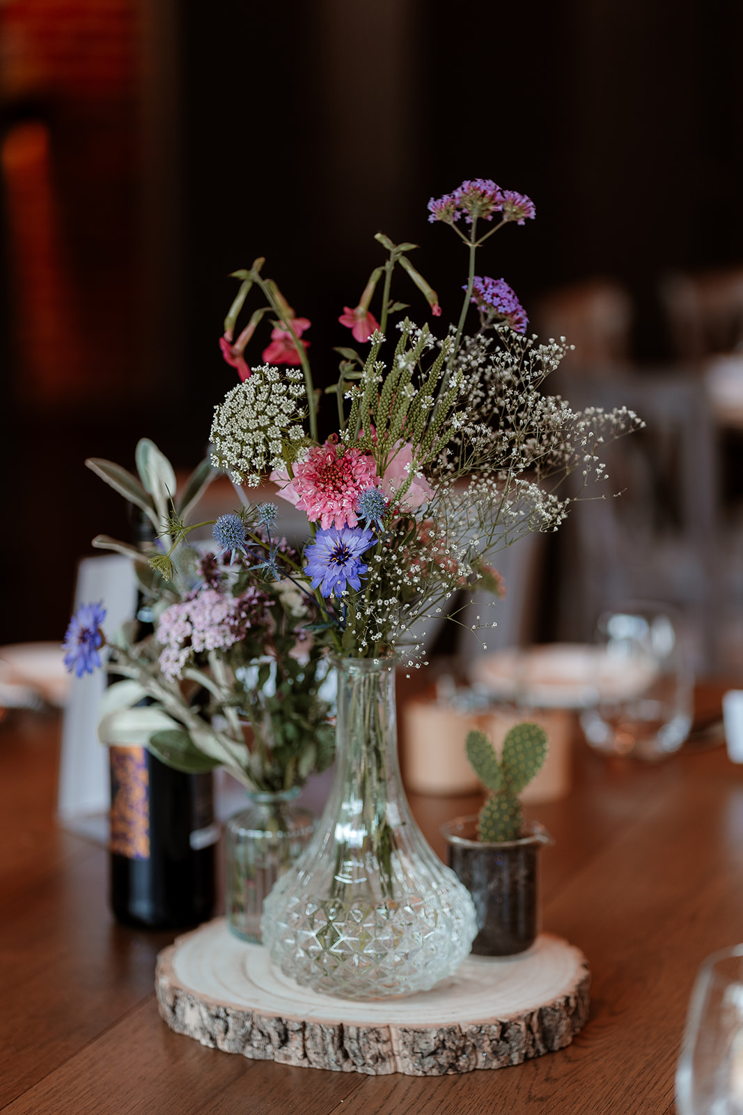 Table decorations with summer flowers at this Syrencot wedding