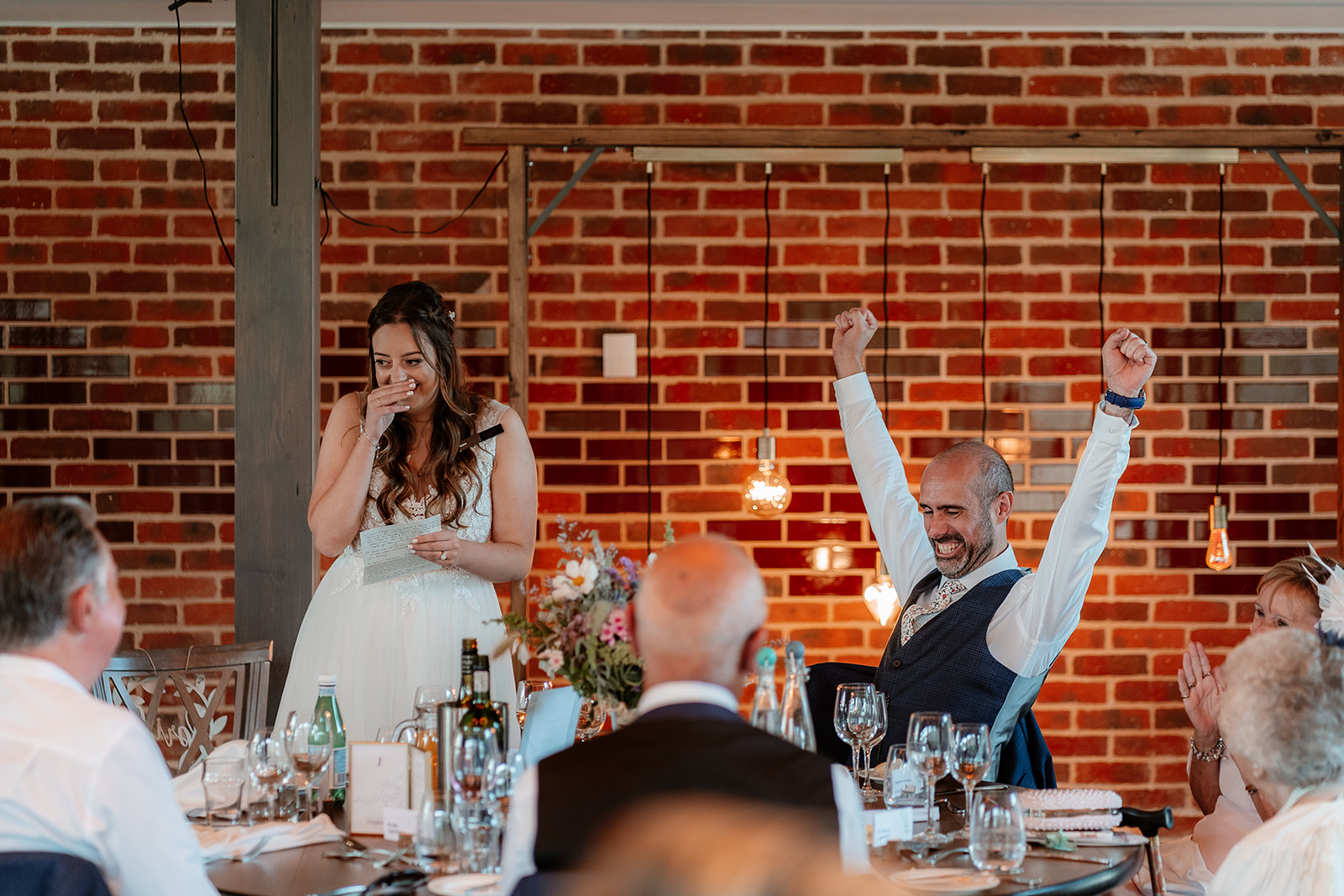 Wedding speeches in the luxurious Farmshed at this Syrencot summer wedding