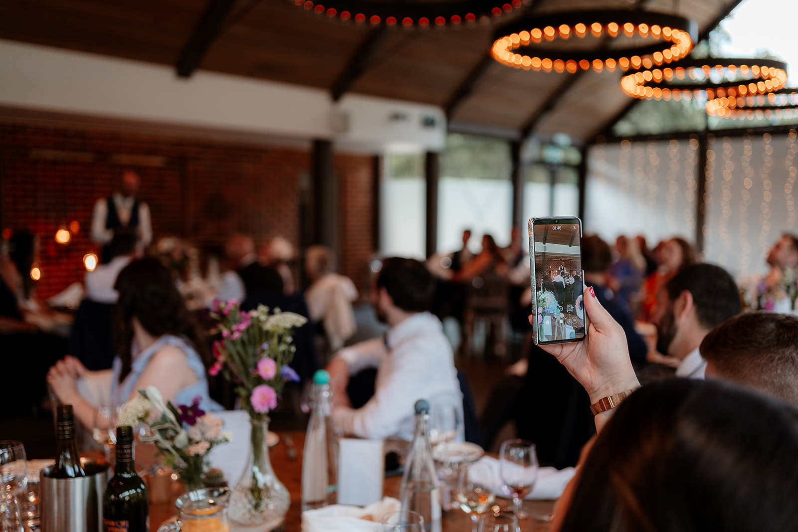 Wedding speeches in the luxurious Farmshed at this Syrencot summer wedding