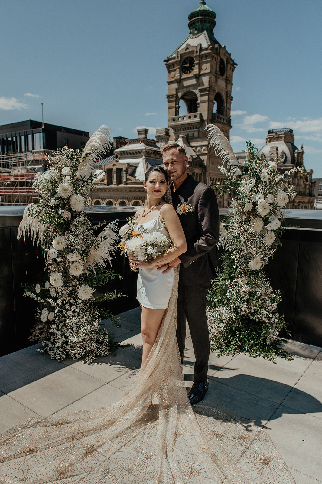 Bride and groom pose on the rooftop of Kinn Guesthouse Downtown Milwaukee during their wedding